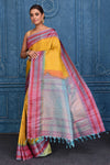Buy yellow striped pure Gadhwal silk silk sari online in USA with bluish pink border. Keep your ethnic wardrobe up to date with latest designer saris, pure silk sarees, Kanchipuram silk sarees, handwoven silk sarees, tussar silk sarees, embroidered sarees from Pure Elegance Indian saree store in USA.-full view