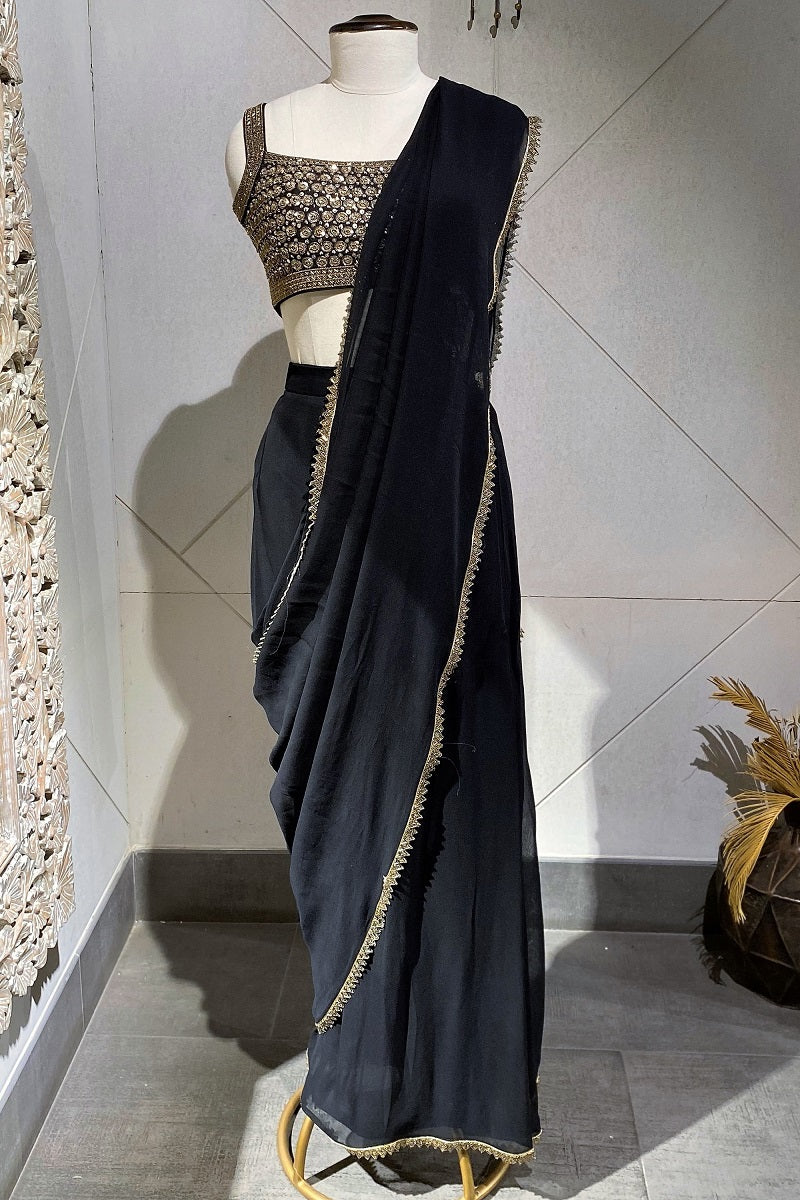 Buy a Beautiful black embroidered belted organza sari with cut dana and tikki work. It comes with a designer embroidered saree blouse. Shop designer saris online in the USA from Pure Elegance. Make a fashion statement on festive occasions and weddings with designer sarees, designer suits, Indian dresses, Anarkali suits, palazzo suits, designer gowns, sharara suits, and embroidered sarees from Pure Elegance Indian fashion store in the USA.