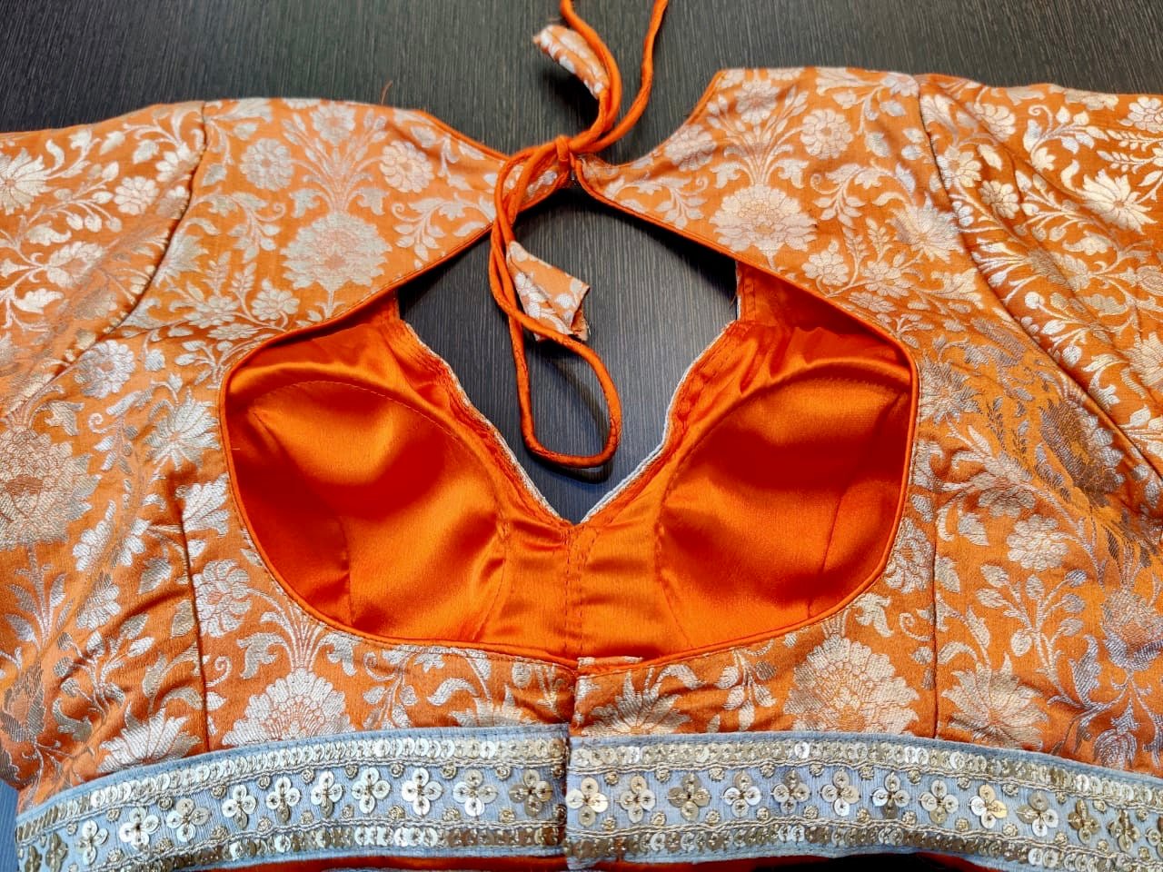 Buy stunning orange designer saree blouse online in USA with embroidered lace. Elevate your ethnic saree style with a tasteful collection of designer saree blouses, embroidered saree blouses, Banarasi saree blouse, silk sari blouse from Pure Elegance Indian clothing store in USA.-back