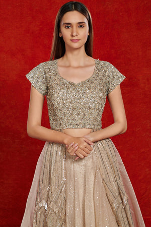 Buy stunning beige embellished lehenga online in USA. Make a fashion statement on festive occasions and weddings with designer suits, Indian dresses, Anarkali suits, palazzo suits, designer gowns, sharara suits from Pure Elegance Indian fashion store in USA.