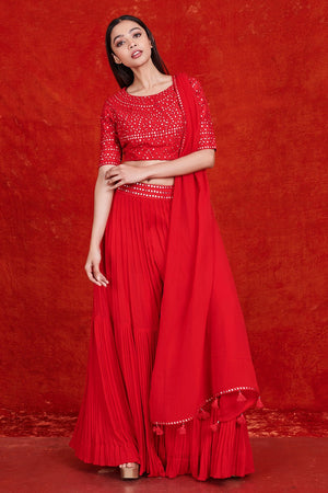 Buy stunning red mirror work sharara suit online in USA with dupatta.  Make a fashion statement on festive occasions and weddings with designer suits, Indian dresses, Anarkali suits, palazzo suits, designer gowns, sharara suits from Pure Elegance Indian fashion store in USA.-front