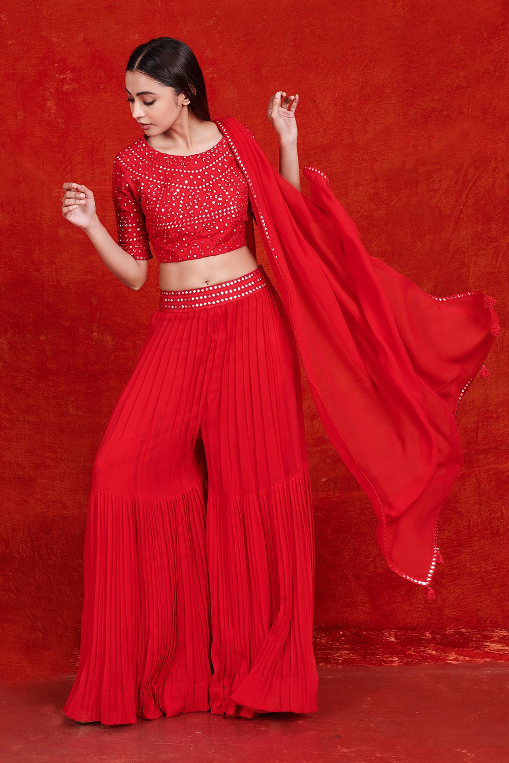 Buy stunning red mirror work sharara suit online in USA with dupatta.  Make a fashion statement on festive occasions and weddings with designer suits, Indian dresses, Anarkali suits, palazzo suits, designer gowns, sharara suits from Pure Elegance Indian fashion store in USA.-full view