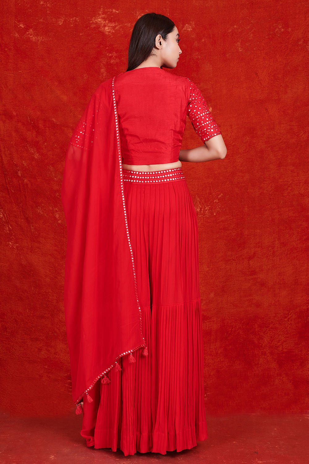 Buy stunning red mirror work sharara suit online in USA with dupatta.  Make a fashion statement on festive occasions and weddings with designer suits, Indian dresses, Anarkali suits, palazzo suits, designer gowns, sharara suits from Pure Elegance Indian fashion store in USA.-back