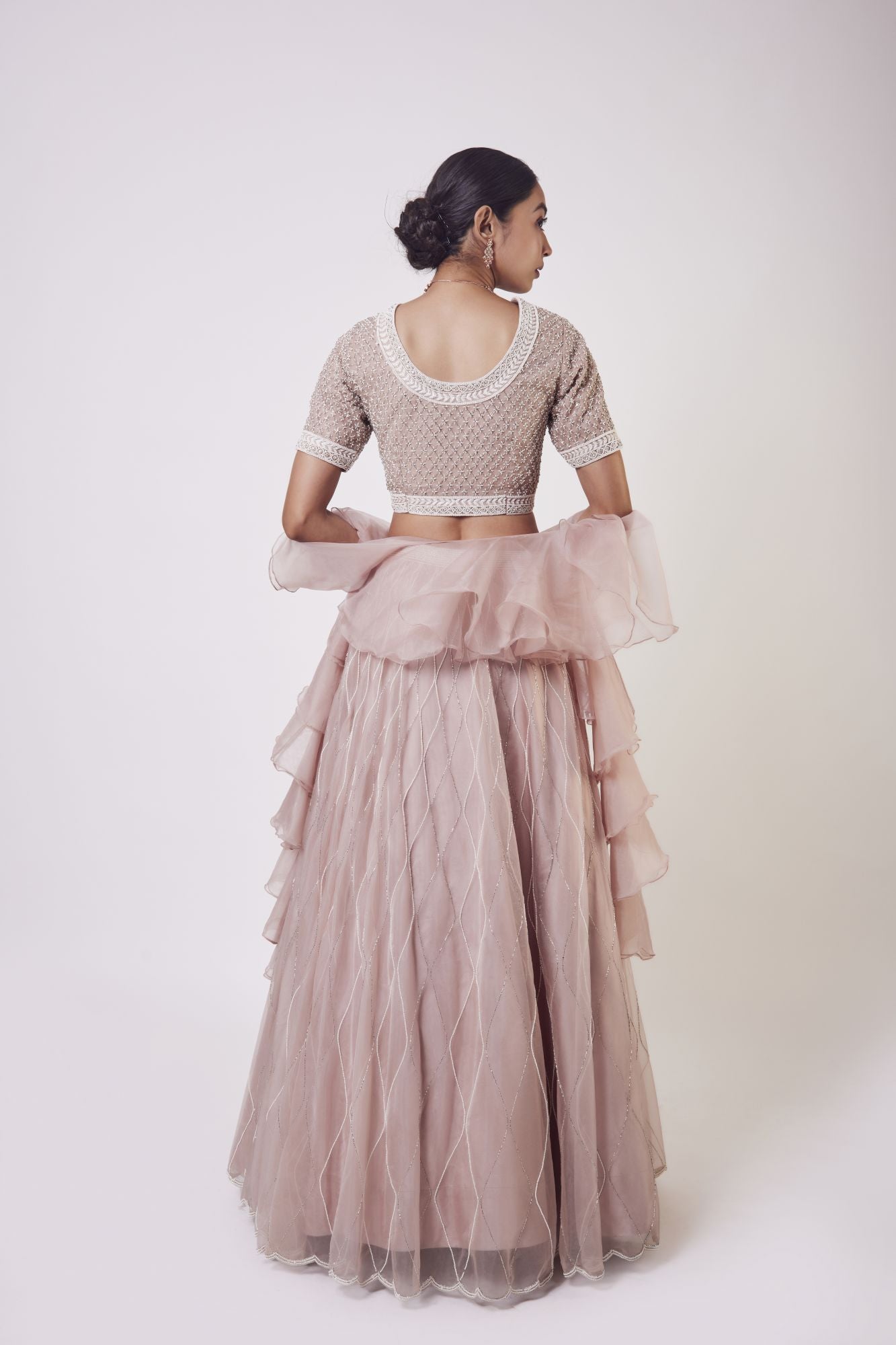 Shop stunning peach organza lehenga online in USA with ruffle dupatta. Get festive ready in beautiful designer Anarkali suits, designer lehenga, wedding gowns, sharara suits, designer sarees from Pure Elegance Indian fashion store in USA.-back