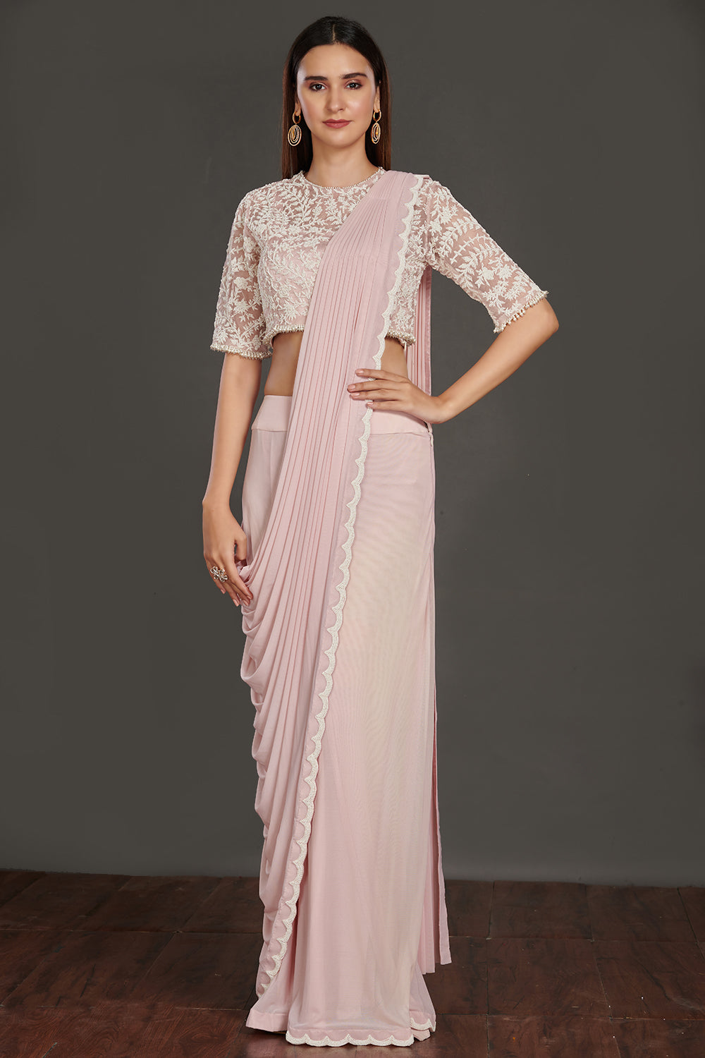 Shop gorgeous powder pink satin saree online in USA with strappy blouse and crop jacket. Make a fashion statement on festive occasions and weddings with designer suits, Indian dresses, Anarkali suits, palazzo suits, designer gowns, sharara suits from Pure Elegance Indian fashion store in USA.-full view