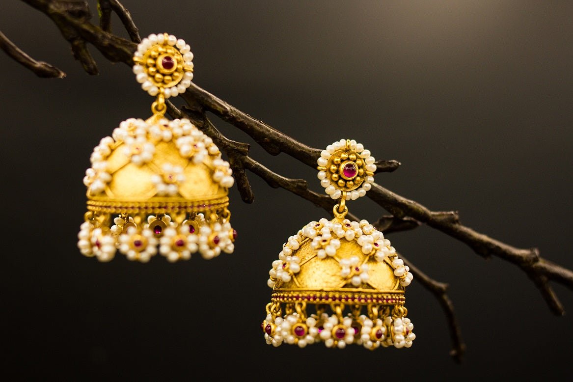 Buy Amrapali silver gold plated pearl flowers jhumka earrings online in USA. Raise your ethnic style quotient on special occasions with exquisite Indian jewelry from Pure Elegance Indian clothing store in USA. Enhance your Indian look with silver gold plated jewelry, necklaces, fashion jewelry available online.-closeup