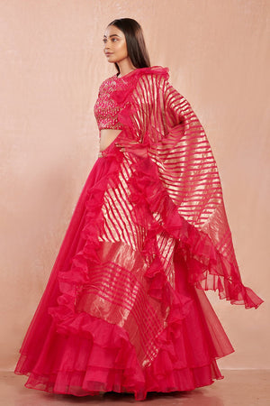 Shop stunning rani pink organza lehenga online in USA with ruffled dupatta. Make a fashion statement on festive occasions and weddings with designer suits, Indian dresses, Anarkali suits, palazzo suits, designer gowns, sharara suits from Pure Elegance Indian fashion store in USA.-side