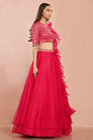 Shop stunning rani pink organza lehenga online in USA with ruffled dupatta. Make a fashion statement on festive occasions and weddings with designer suits, Indian dresses, Anarkali suits, palazzo suits, designer gowns, sharara suits from Pure Elegance Indian fashion store in USA.-right