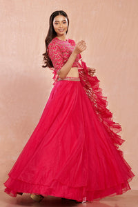 Shop stunning rani pink organza lehenga online in USA with ruffled dupatta. Make a fashion statement on festive occasions and weddings with designer suits, Indian dresses, Anarkali suits, palazzo suits, designer gowns, sharara suits from Pure Elegance Indian fashion store in USA.-full view