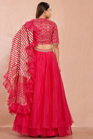Shop stunning rani pink organza lehenga online in USA with ruffled dupatta. Make a fashion statement on festive occasions and weddings with designer suits, Indian dresses, Anarkali suits, palazzo suits, designer gowns, sharara suits from Pure Elegance Indian fashion store in USA.-back