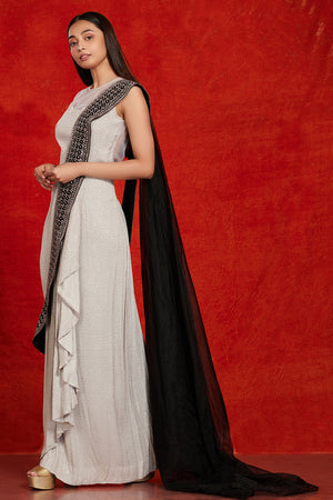 Buy stunning grey and black embellished saree gown online in USA. Make a fashion statement on festive occasions and weddings with palazzo suits, sharara suits, partywear dresses, salwar suits from Pure Elegance Indian fashion store in USA.-left