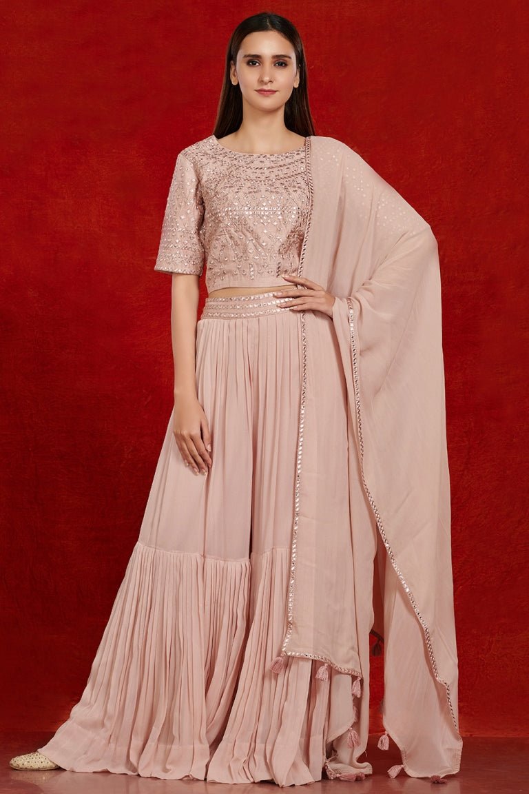 Shop gorgeous dusty pink mirror work sharara suit online in USA with dupatta.  Make a fashion statement on festive occasions and weddings with designer suits, Indian dresses, Anarkali suits, palazzo suits, designer gowns, sharara suits from Pure Elegance Indian fashion store in USA.-full view