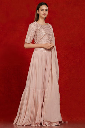 Shop gorgeous dusty pink mirror work sharara suit online in USA with dupatta.  Make a fashion statement on festive occasions and weddings with designer suits, Indian dresses, Anarkali suits, palazzo suits, designer gowns, sharara suits from Pure Elegance Indian fashion store in USA.-right