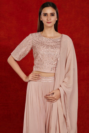 Shop gorgeous dusty pink mirror work sharara suit online in USA with dupatta.  Make a fashion statement on festive occasions and weddings with designer suits, Indian dresses, Anarkali suits, palazzo suits, designer gowns, sharara suits from Pure Elegance Indian fashion store in USA.-closeup