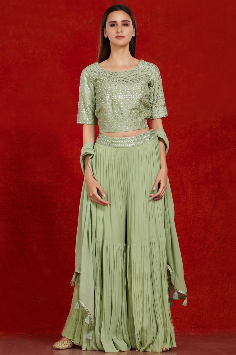 Buy pista green mirror work sharara suit online in USA with dupatta.  Make a fashion statement on festive occasions and weddings with designer suits, Indian dresses, Anarkali suits, palazzo suits, designer gowns, sharara suits from Pure Elegance Indian fashion store in USA.-full view