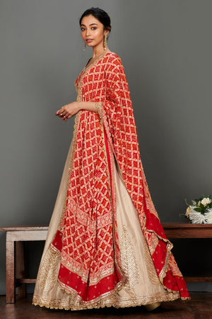 Shop stunning beige embroidered lehenga online in USA with red bandhej dupatta. Make a fashion statement on festive occasions and weddings with palazzo suits, sharara suits, partywear dresses, salwar suits from Pure Elegance Indian fashion store in USA.-left