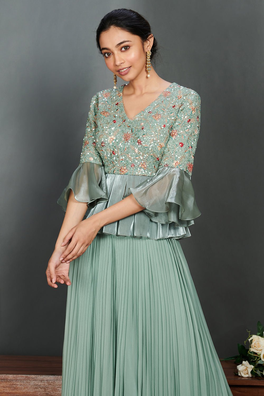 Shop beautiful aqua green peplum blouse online in USA with pleated georgette skirt. Make a fashion statement on festive occasions and weddings with designer suits, Indian dresses, Anarkali suits, palazzo suits, designer gowns, sharara suits from Pure Elegance Indian fashion store in USA.-closeup