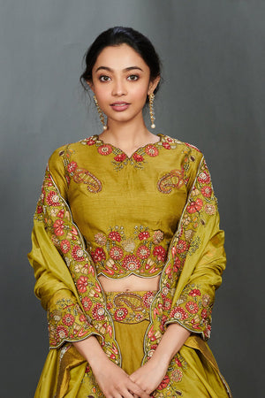 Buy beautiful olive green scalloped lehenga set online in USA. Make a fashion statement on festive occasions and weddings with designer suits, Indian dresses, Anarkali suits, palazzo suits, designer gowns, sharara suits from Pure Elegance Indian fashion store in USA.-closeup