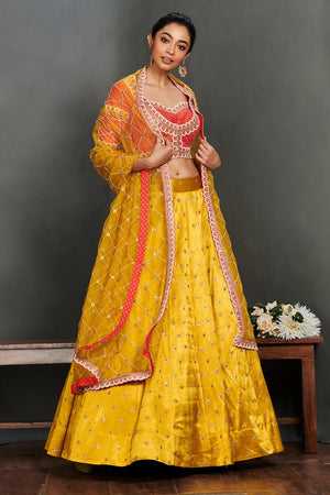 Shop gorgeous yellow embroidered cotton lehenga online in USA with coral choli. Make a fashion statement on festive occasions and weddings with palazzo suits, sharara suits, partywear dresses, salwar suits from Pure Elegance Indian fashion store in USA.-front