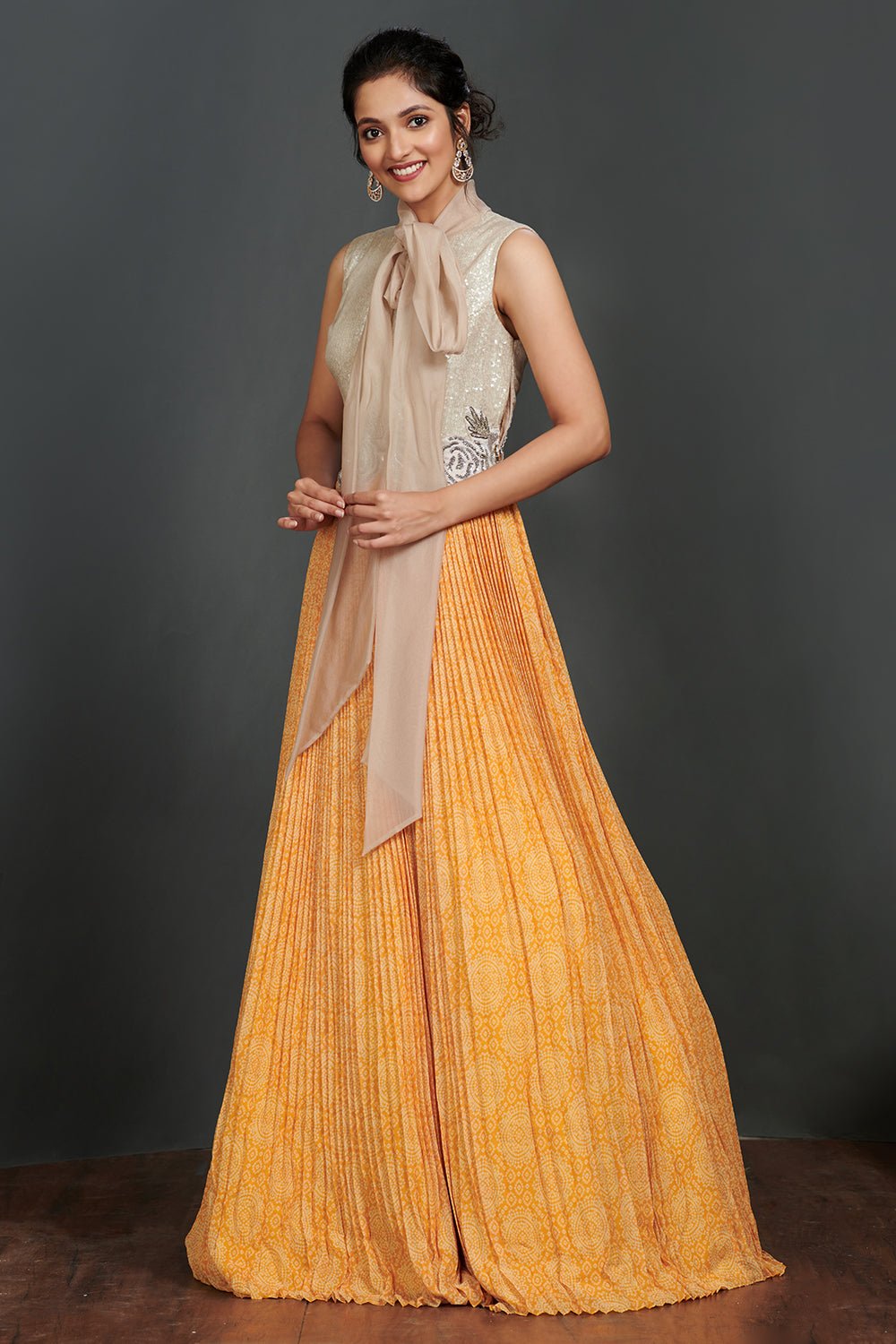 Shop beautiful silver and light orange pleated gown online in USA with scarf. Make a fashion statement on festive occasions and weddings with palazzo suits, sharara suits, partywear dresses, salwar suits from Pure Elegance Indian fashion store in USA.-side