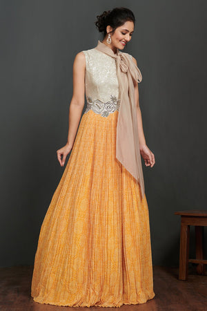 Shop beautiful silver and light orange pleated gown online in USA with scarf. Make a fashion statement on festive occasions and weddings with palazzo suits, sharara suits, partywear dresses, salwar suits from Pure Elegance Indian fashion store in USA.-side
