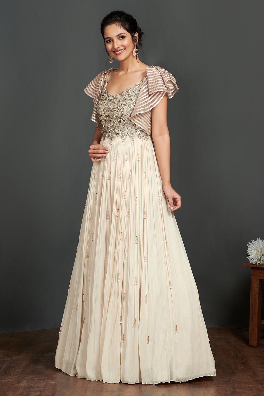 Shop stunning ivory georgette gown online in USA with sequin work bustier. Make a fashion statement on festive occasions and weddings with designer suits, Indian dresses, Anarkali suits, palazzo suits, designer gowns, sharara suits from Pure Elegance Indian fashion store in USA.-left