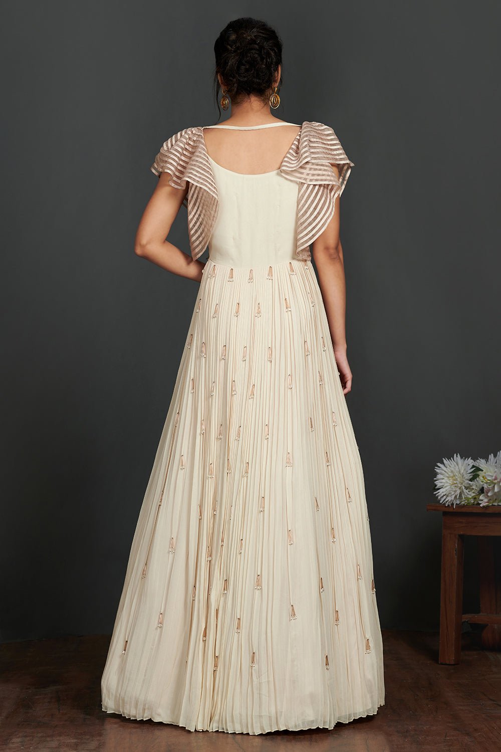 Shop stunning ivory georgette gown online in USA with sequin work bustier. Make a fashion statement on festive occasions and weddings with designer suits, Indian dresses, Anarkali suits, palazzo suits, designer gowns, sharara suits from Pure Elegance Indian fashion store in USA.-back