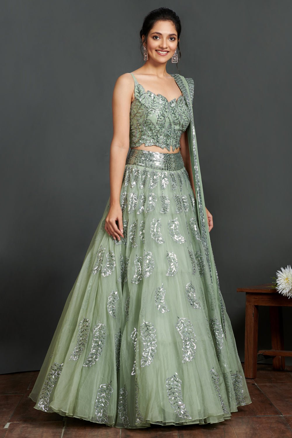 Shop gorgeous sage green organza lehenga online in USA with crop blouse and dupatta. Make a fashion statement on festive occasions and weddings with designer suits, Indian dresses, Anarkali suits, palazzo suits, designer gowns, sharara suits from Pure Elegance Indian fashion store in USA.-full view