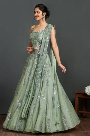 Shop gorgeous sage green organza lehenga online in USA with crop blouse and dupatta. Make a fashion statement on festive occasions and weddings with designer suits, Indian dresses, Anarkali suits, palazzo suits, designer gowns, sharara suits from Pure Elegance Indian fashion store in USA.-left