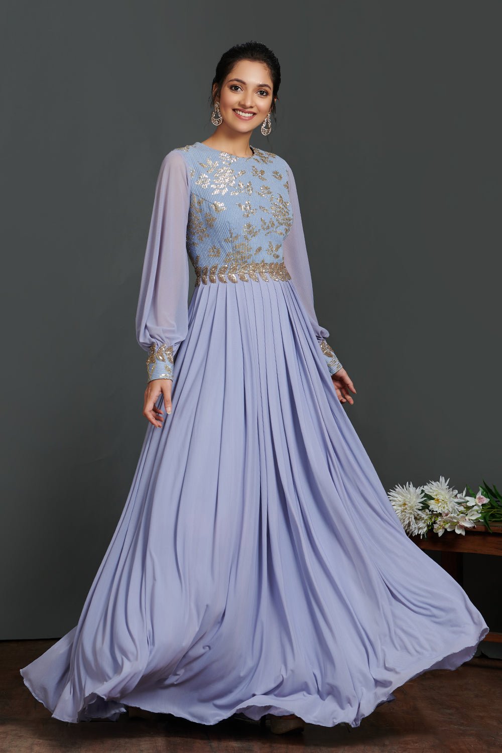 Buy stunning lavender balloon sleeves designer gown online in USA. Make a fashion statement on festive occasions and weddings with palazzo suits, sharara suits, partywear dresses, salwar suits, designer gowns from Pure Elegance Indian fashion store in USA.-flare