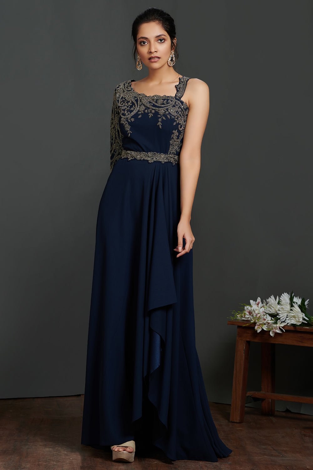 Buy beautiful navy blue antique golden embroidery asymmetric gown online in USA. Make a fashion statement on festive occasions and weddings with palazzo suits, sharara suits, partywear dresses, salwar suits from Pure Elegance Indian fashion store in USA.-front