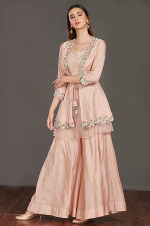 Shop beautiful light pink embroidered peplum jacket online in USA with flared palazzo. Make a fashion statement on festive occasions and weddings with palazzo suits, sharara suits, partywear dresses, salwar suits from Pure Elegance Indian fashion store in USA.-front