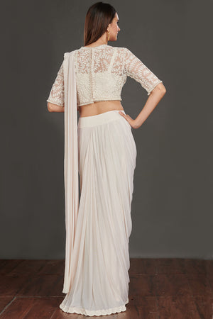 Shop stunning off-white satin saree online in USA with strappy blouse with crop jacket. Make a fashion statement on festive occasions and weddings with designer suits, Indian dresses, Anarkali suits, palazzo suits, designer gowns, sharara suits from Pure Elegance Indian fashion store in USA.-back