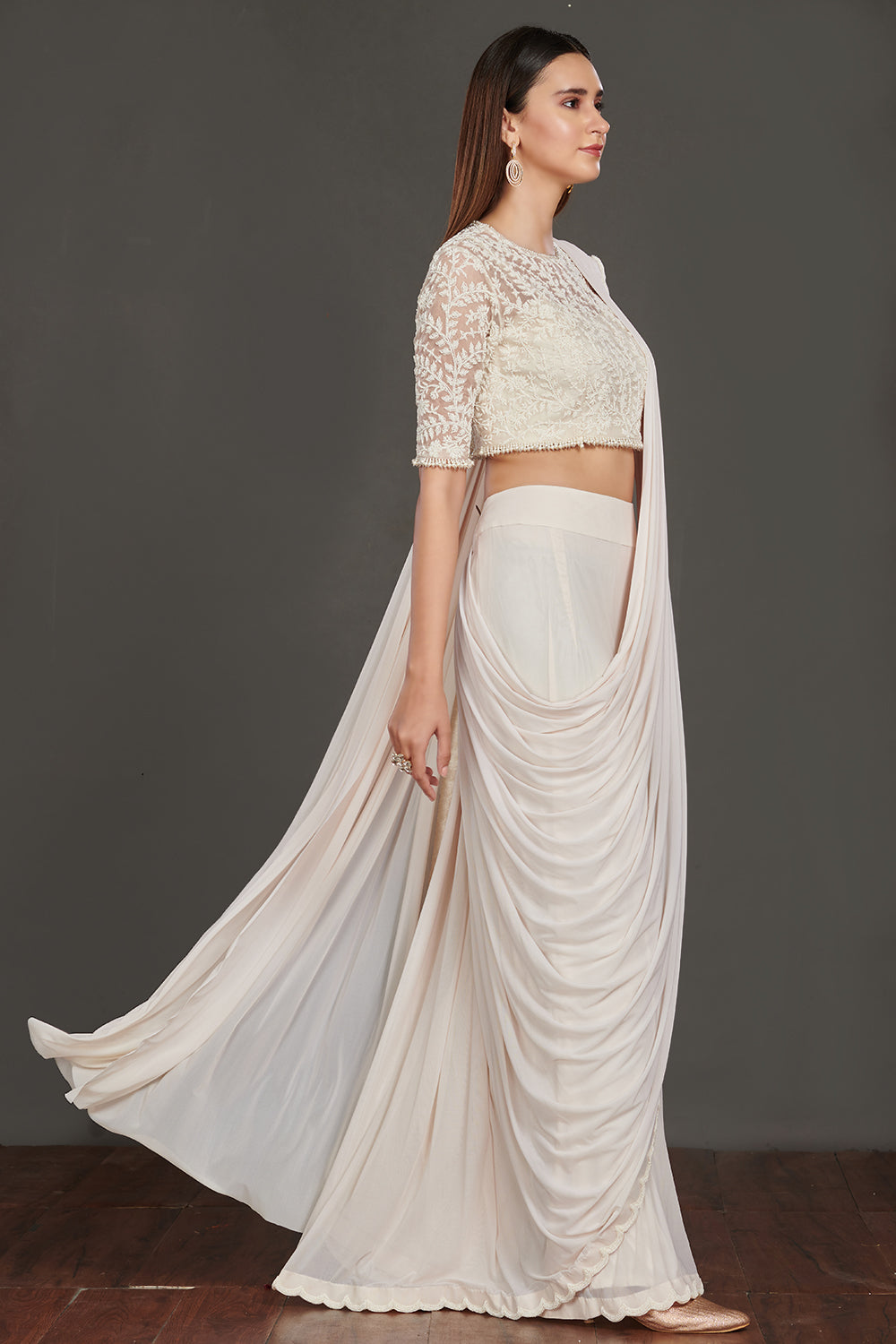 Shop stunning off-white satin saree online in USA with strappy blouse with crop jacket. Make a fashion statement on festive occasions and weddings with designer suits, Indian dresses, Anarkali suits, palazzo suits, designer gowns, sharara suits from Pure Elegance Indian fashion store in USA.-side