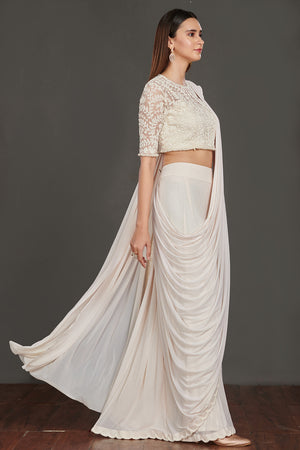 Shop stunning off-white satin saree online in USA with strappy blouse with crop jacket. Make a fashion statement on festive occasions and weddings with designer suits, Indian dresses, Anarkali suits, palazzo suits, designer gowns, sharara suits from Pure Elegance Indian fashion store in USA.-side