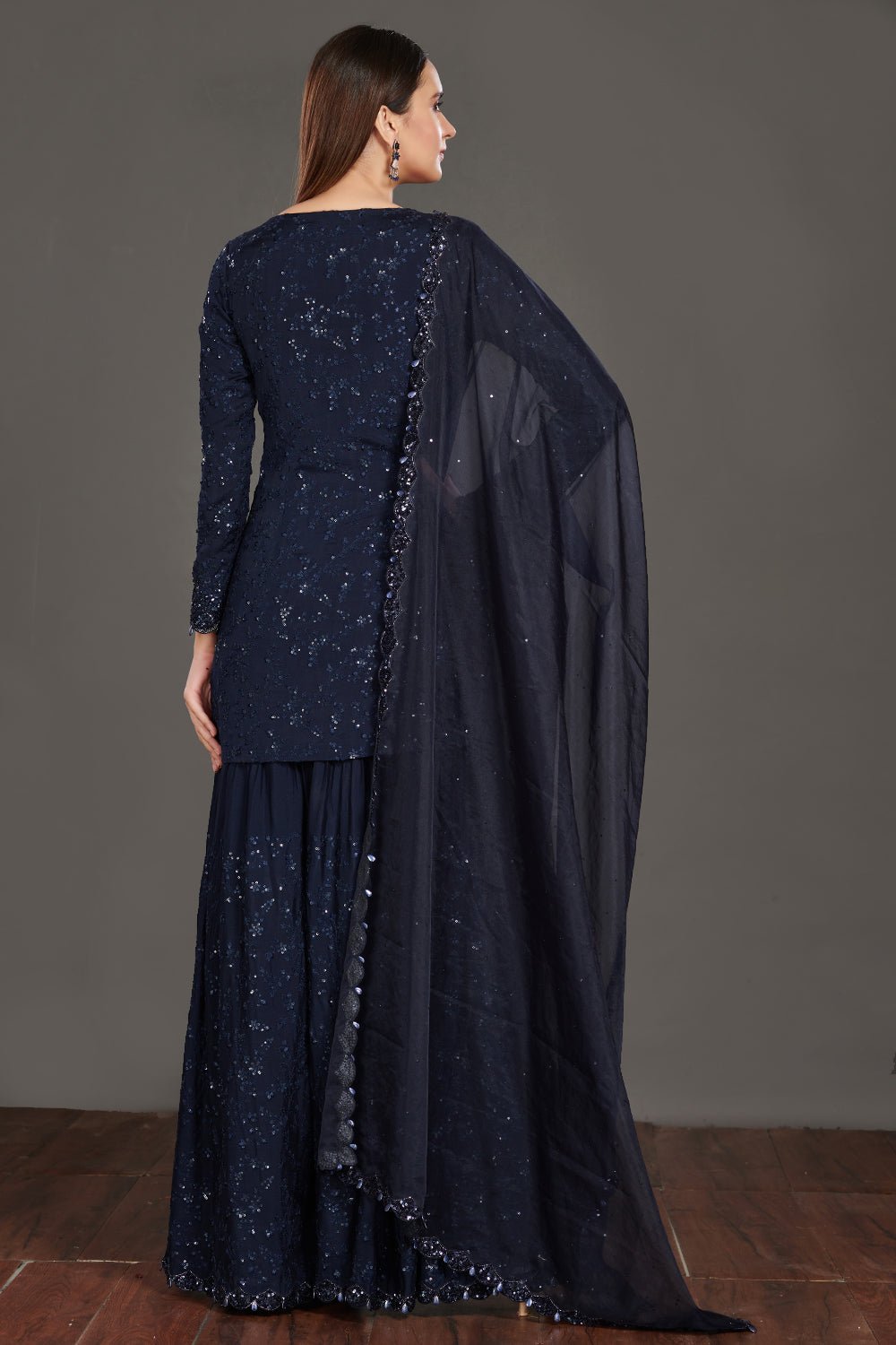 Buy stunning navy blue shimmer sharara suit online in USA. Make a fashion statement on festive occasions and weddings with palazzo suits, sharara suits, partywear dresses, salwar suits from Pure Elegance Indian fashion store in USA.-back