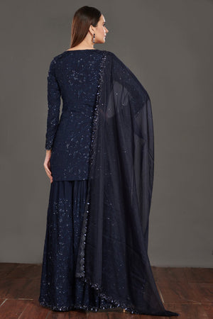 Buy stunning navy blue shimmer sharara suit online in USA. Make a fashion statement on festive occasions and weddings with palazzo suits, sharara suits, partywear dresses, salwar suits from Pure Elegance Indian fashion store in USA.-back