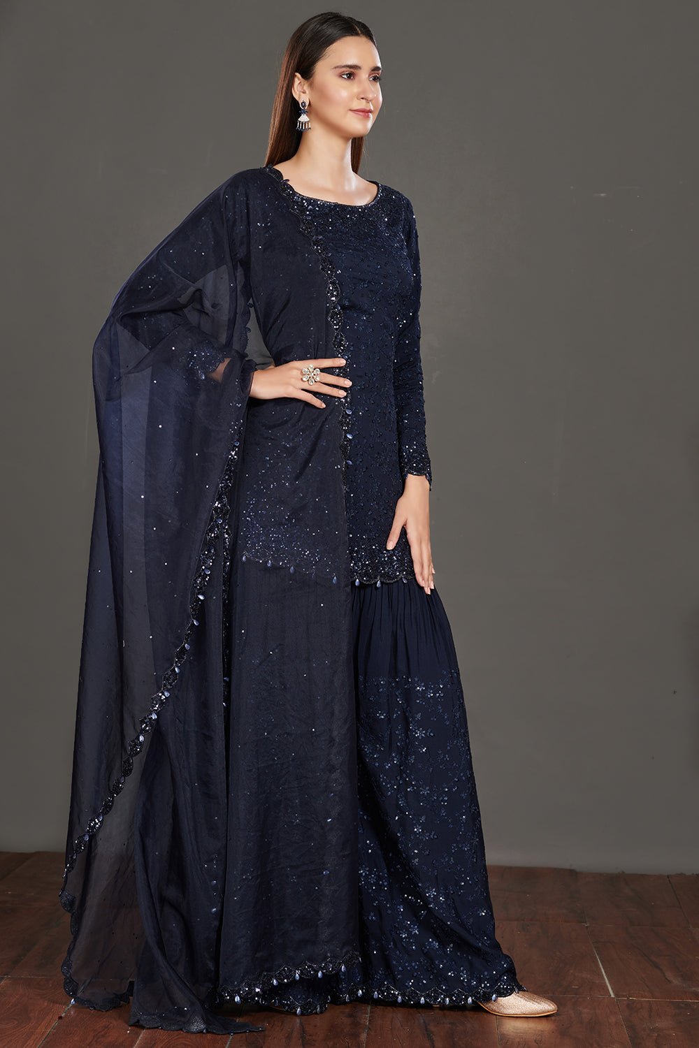 Buy stunning navy blue shimmer sharara suit online in USA. Make a fashion statement on festive occasions and weddings with palazzo suits, sharara suits, partywear dresses, salwar suits from Pure Elegance Indian fashion store in USA.-right