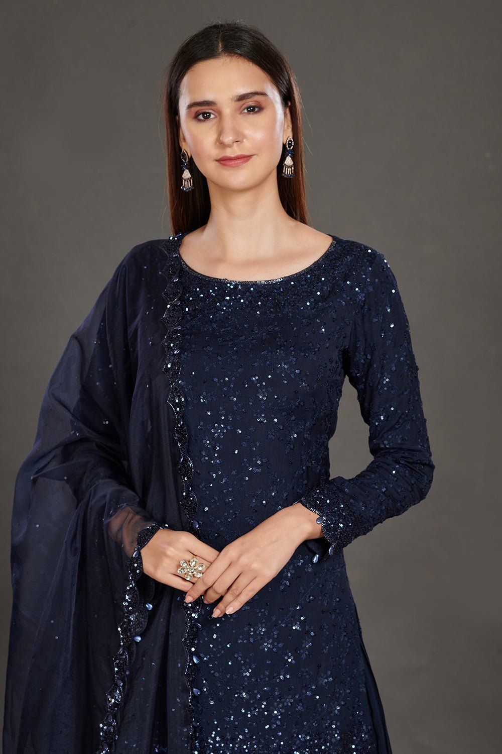 Buy stunning navy blue shimmer sharara suit online in USA. Make a fashion statement on festive occasions and weddings with palazzo suits, sharara suits, partywear dresses, salwar suits from Pure Elegance Indian fashion store in USA.-neckline