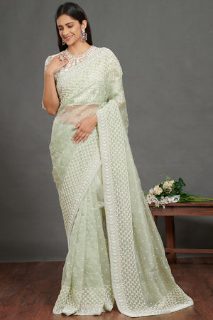 Shop mint green self embroidered saree online in USA with green lace saree blouse. Make a fashion statement on festive occasions and weddings with designer suits, Indian dresses, Anarkali suits, palazzo suits, designer gowns, sharara suits from Pure Elegance Indian fashion store in USA.-front