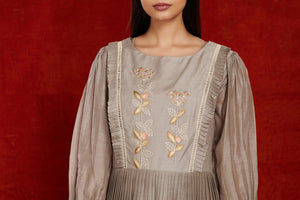 Buy stunning grey balloon sleeves muslin gown online in USA with pastel embroidery. Make a fashion statement on festive occasions and weddings with palazzo suits, sharara suits, partywear dresses, salwar suits from Pure Elegance Indian fashion store in USA.-embroidery