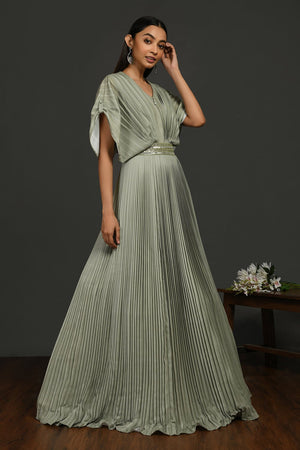 Buy stunning tea green pleated gown online in USA with metallic belt. Make a fashion statement on festive occasions and weddings with designer suits, Indian dresses, Anarkali suits, palazzo suits, designer gowns, sharara suits from Pure Elegance Indian fashion store in USA.-right