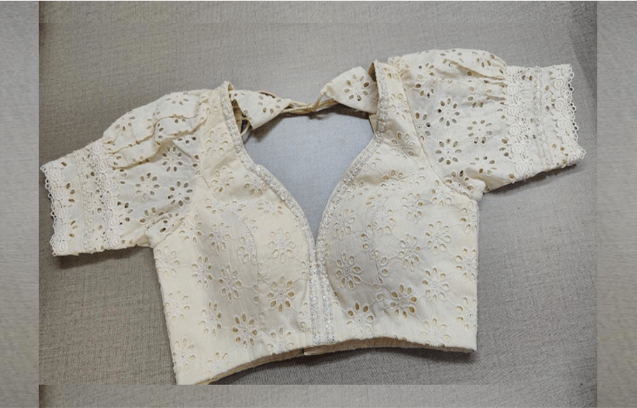 Buy white color Chikankari embroidery work saree blouse, has a U-neck, half puffy sleeves with hook & tie-up at the back. Pair it with cotton sarees to have a smooth and elegant look this summer. Elevate your Indian ethnic sarees with beautiful readymade sari blouses, embroidered saree blouses, Banarasi saree blouses, designer sari blouses, and choli-cut blouses from Pure Elegance Indian fashion store in USA.-Front View