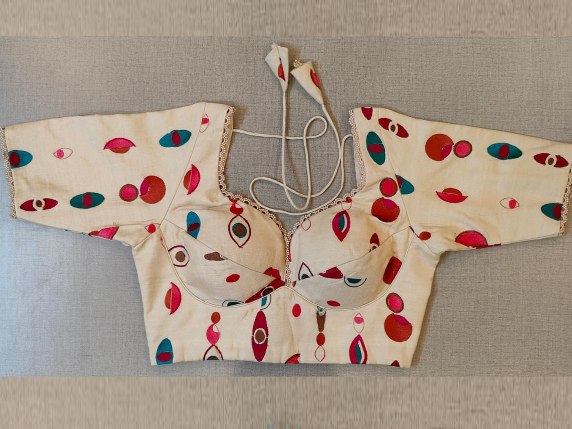 Buy stunning cream choli-cut saree blouse online in USA with multicolor motifs. Elevate your Indian saree style with exquisite readymade sari blouse, embroidered saree blouses, Banarasi saree blouse, designer sari blouse, choli-cut blouses from Pure Elegance Indian clothing store in USA.-full view
