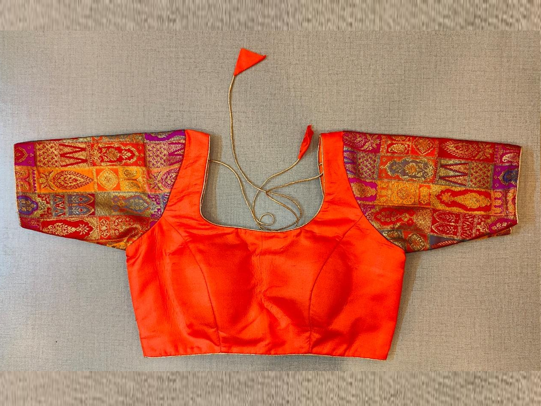 Buy stunning orange saree blouse online in USA with Banarasi sleeves. Elevate your Indian saree style with exquisite readymade sari blouse, embroidered saree blouses, Banarasi saree blouse, designer sari blouse, choli-cut blouses from Pure Elegance Indian clothing store in USA.-full view