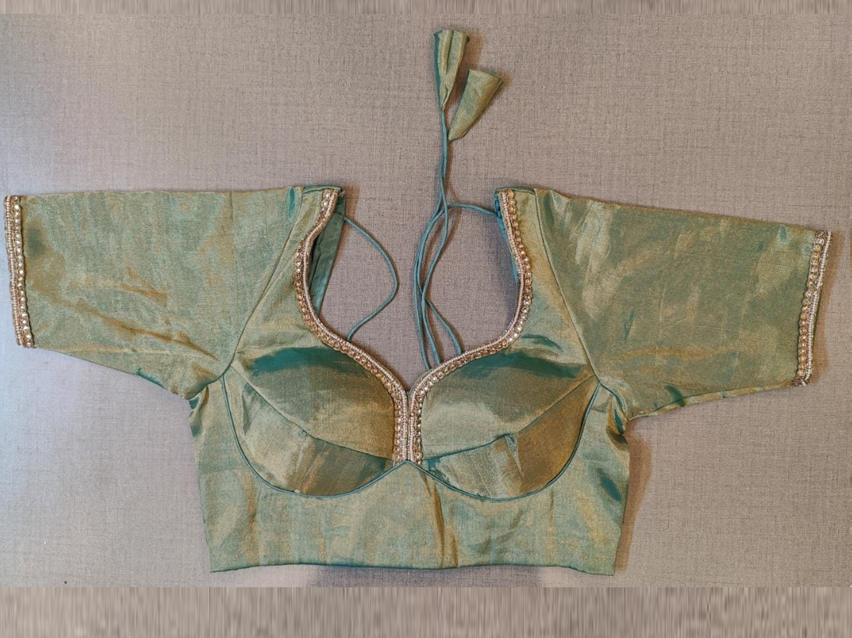 Shop beautiful metallic green choli-cut saree blouse online in USA with stone work lace. Elevate your Indian saree style with exquisite readymade sari blouse, embroidered saree blouses, Banarasi saree blouse, designer sari blouse, choli-cut blouses from Pure Elegance Indian clothing store in USA.-full view