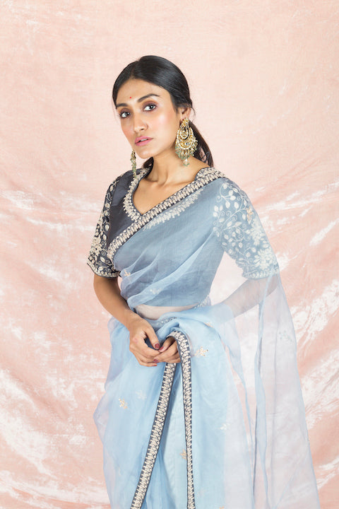 Buy stunning light blue embroidered organza saree online in USA with grey embroidered saree blouse. Champion ethnic fashion on weddings and festivals with a stunning collection of designer sarees, handloom saris with blouse, wedding sarees, from Pure Elegance Indian fashion store in USA.-closeup