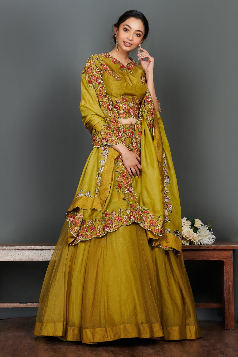 Buy beautiful olive green scalloped lehenga set online in USA. Make a fashion statement on festive occasions and weddings with designer suits, Indian dresses, Anarkali suits, palazzo suits, designer gowns, sharara suits from Pure Elegance Indian fashion store in USA.-front