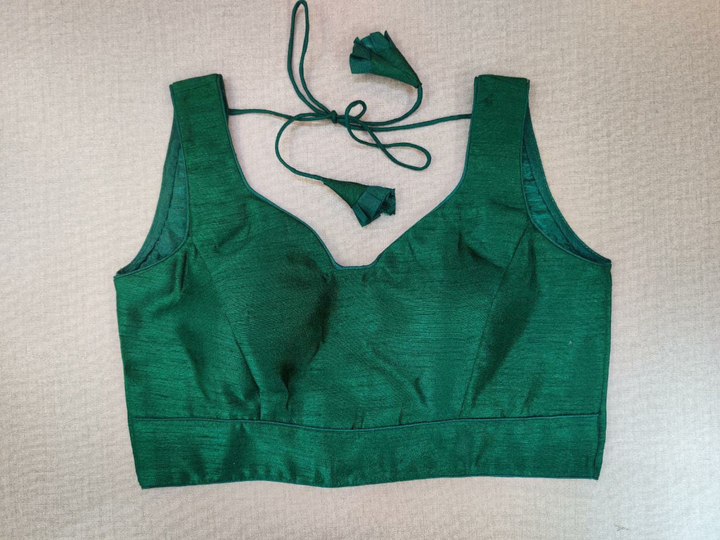 Buy stunning solid green sleeveless saree blouse online in USA. Elevate your Indian ethnic saree looks with beautiful readymade saree blouse, embroidered saree blouses, Banarasi saree blouse, designer sari blouses from Pure Elegance Indian fashion store in USA.-front