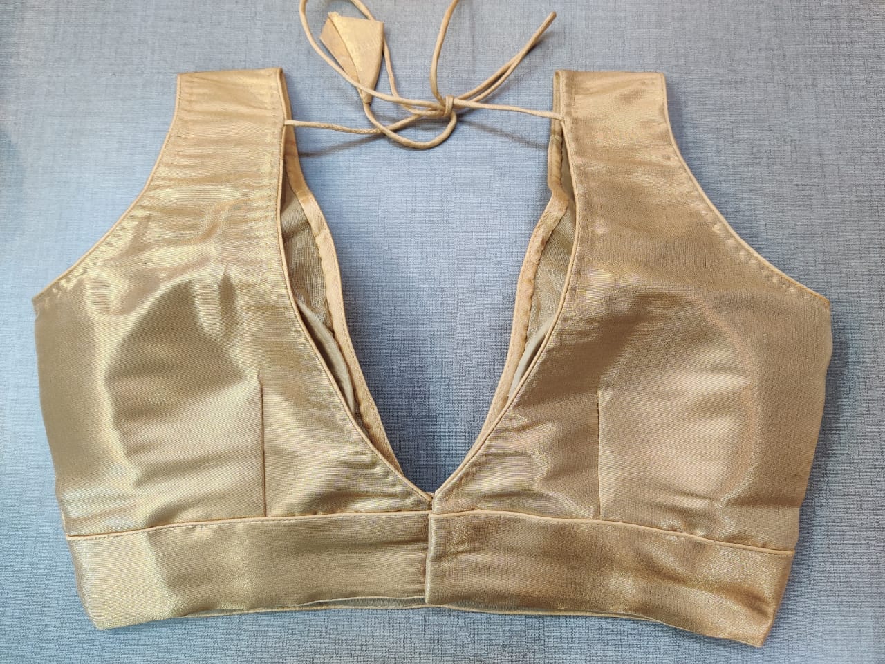 Buy elegant golden sleeveless saree blouse online in USA. Elevate your Indian ethnic sari looks with exquisite readymade saree blouse, embroidered saree blouses, Banarasi sari blouse, designer saree blouse from Pure Elegance Indian clothing store in USA.-back